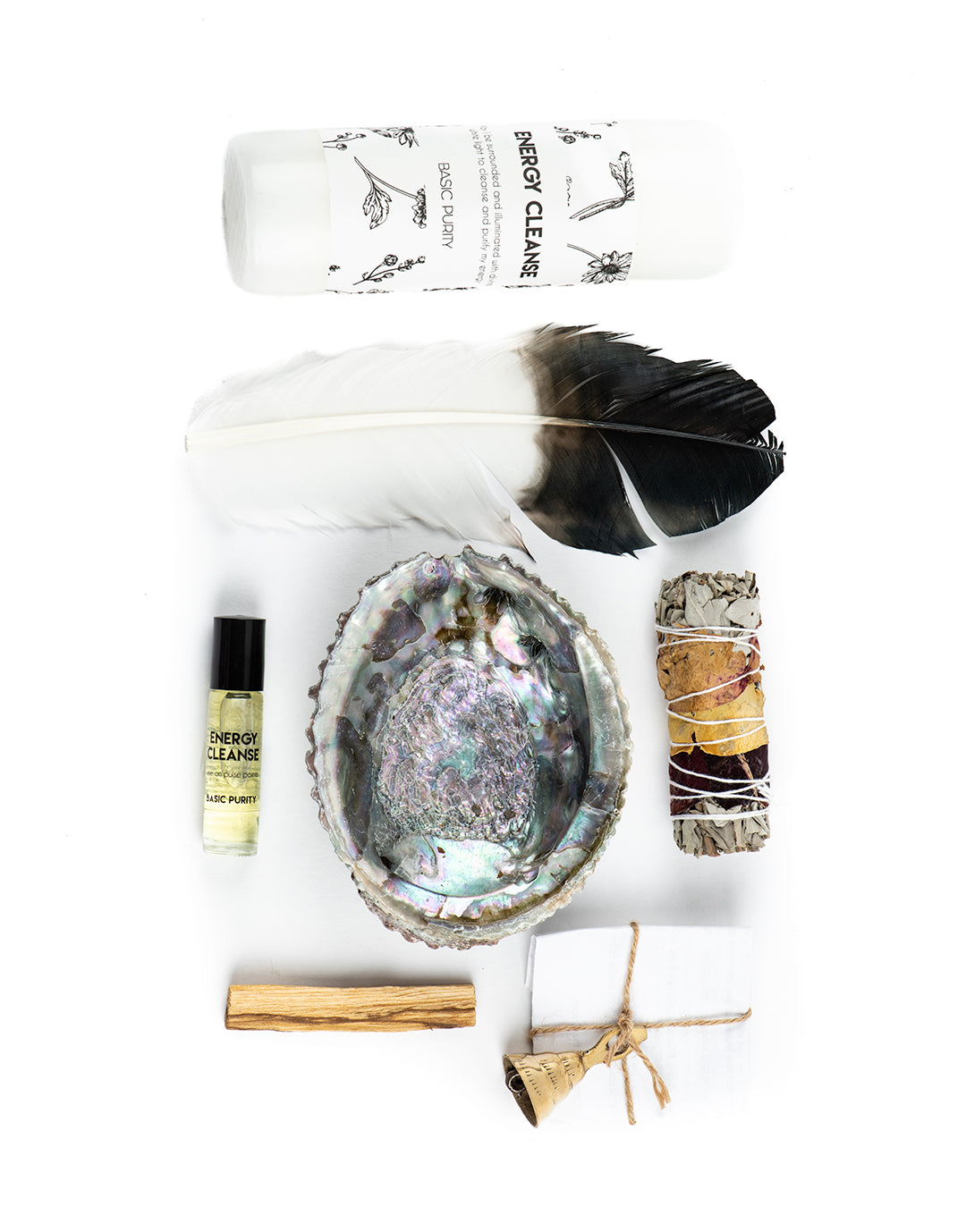 The energy cleansing kit by Mary Armendarez. This includes eagle feather, white candle, abalone shell, cedar/ sage bundle, bell, energy cleanse roll on, quartz crystal, Santo Palo stick, lavender bouquet, and ritual instructions.